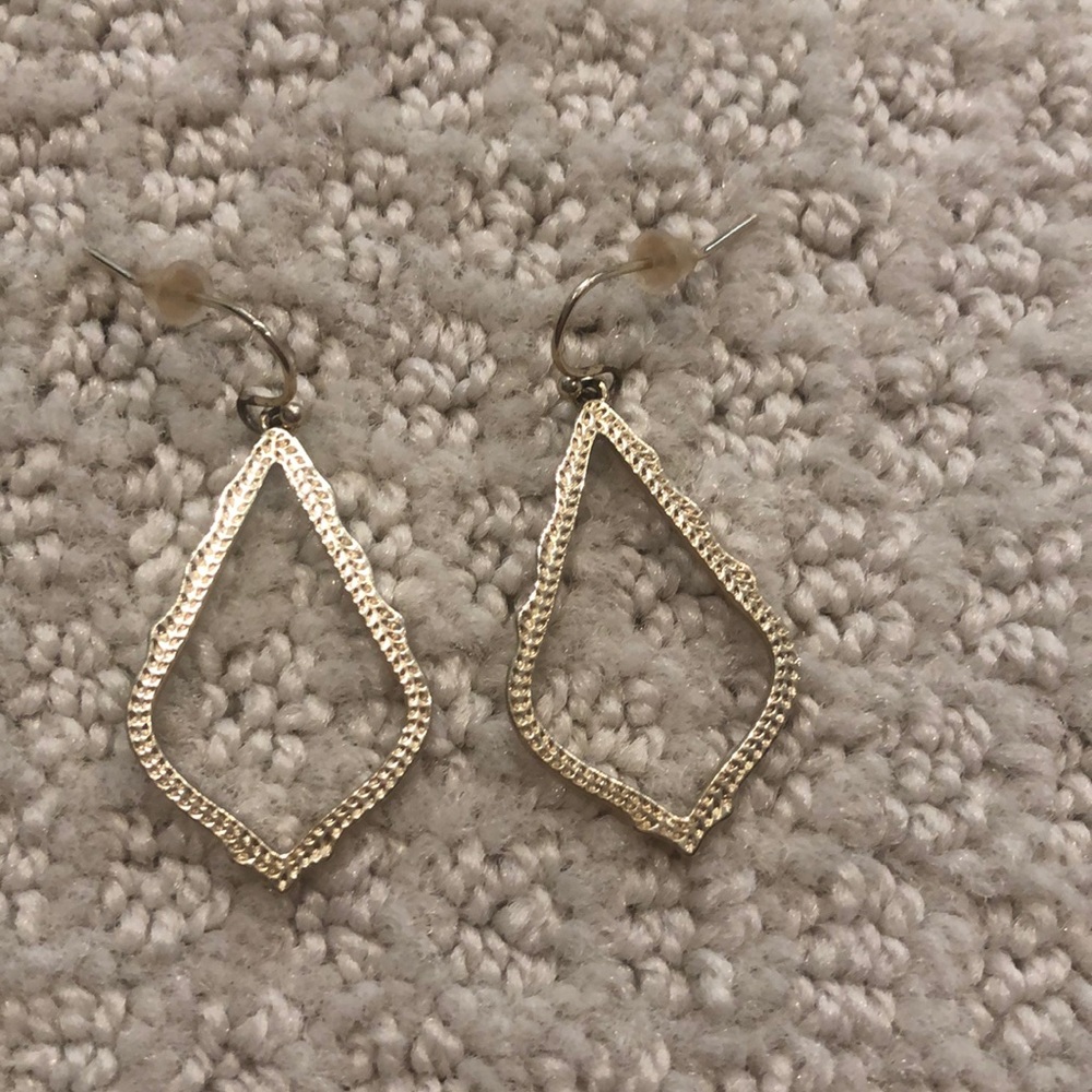 Kendra Scott gold earrings.
